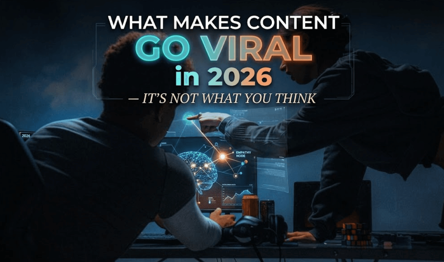 Two people in a dimly lit room looking intently at a computer screen displaying a glowing digital network and brain graphic. One person is leaning over the desk, pointing at the monitor. The image features a bold text overlay that reads: 'WHAT MAKES CONTENT GO VIRAL in 2026 — IT'S NOT WHAT YOU THINK'